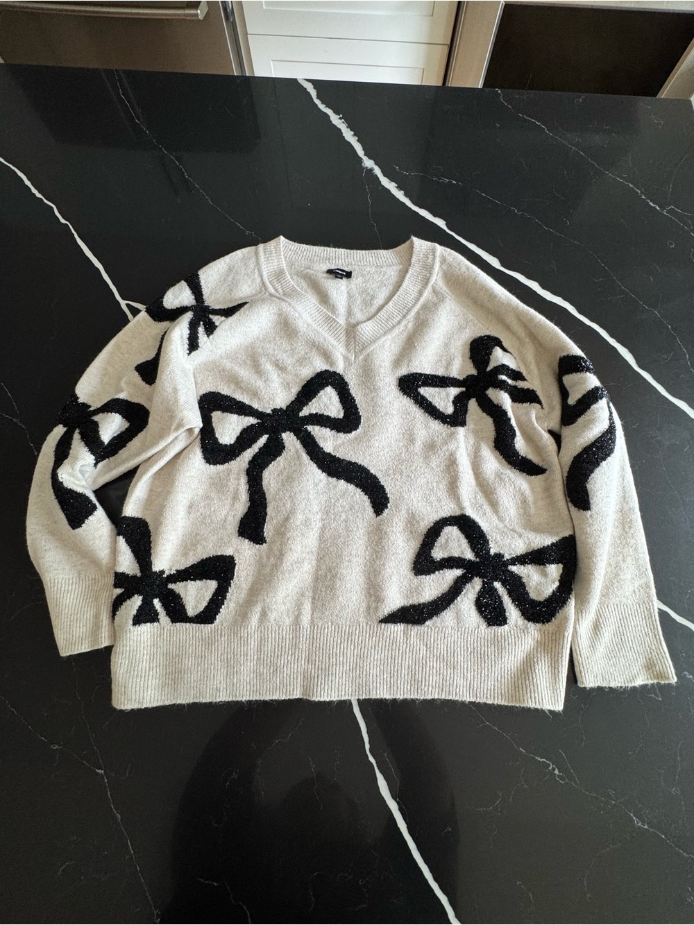 Express Cream V-Neck Sweater with Black Bow Pattern